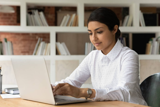Young Indian female employee work on laptop - Foto, Imagem