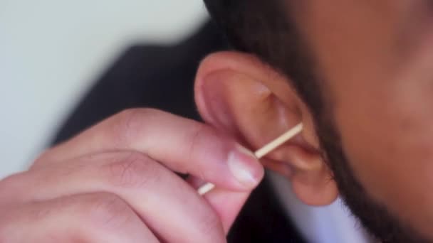 close-up beelden van de man schoonmaken van zijn oren met katoen knop - Video