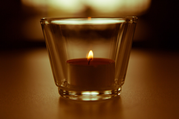 Burning candle with blurred light in the back - Photo, Image