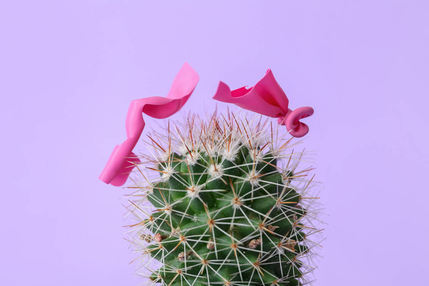 Cactus and popped air balloon on color background - Photo, Image