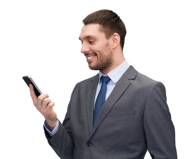 Young smiling businessman with smartphone - Fotó, kép