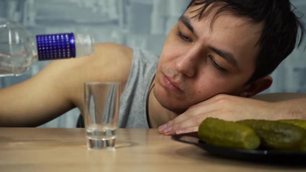 alcoholic drinks vodka and eats cucumbers - Footage, Video