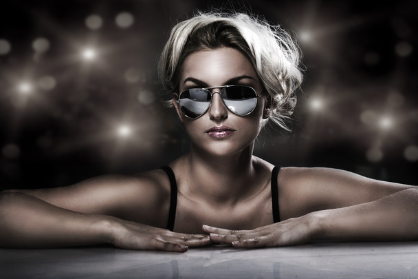 Studio shot of young blonde wearing stylish sunglasses - Photo, Image