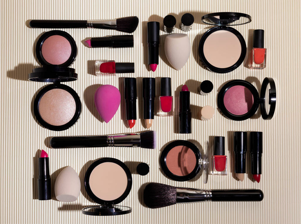 flat lay of decorative cosmetics for makeup, brushes and sponges for the face on a beige background - Photo, Image
