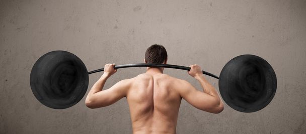 Funny skinny guy lifting weights - 写真・画像