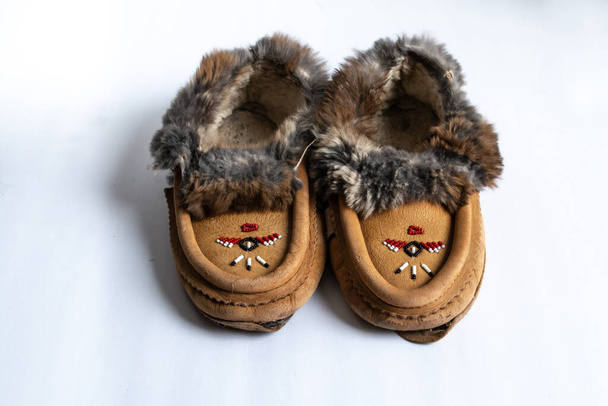 A pair of Indigenous-made, beaded rabbit fur moccasin slippers in Southwestern Ontario, Canada. - Photo, Image