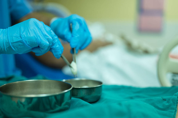 A nurse is preparing a tool to dressing the patient's wound. - Photo, Image