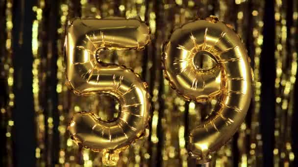 The golden number 59 fifty nine is made from an inflatable balloon on a yellow background. One of the complete set of numbers. Birthday, anniversary, date concept - Footage, Video