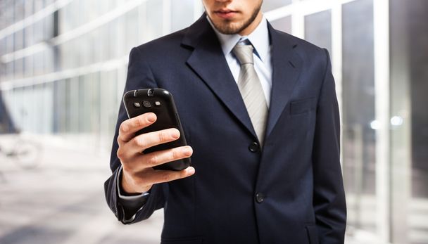 Businessman using a smartphone - Fotó, kép