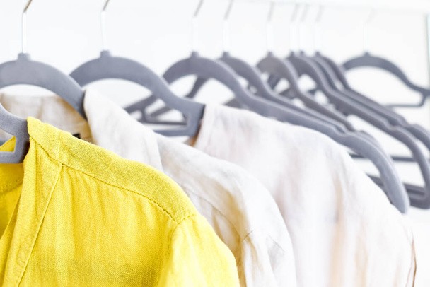 Linen clothes on gray hangers on the clothes rack. Slow Fashion. Conscious consumption. Crisis in the fashion industry, retail. Eco-friendly, Sustainable Sale concept. Zero waste. Black friday. - Photo, Image