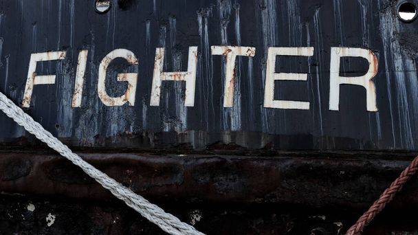 La palabra luchador en un viejo barco - Foto, imagen