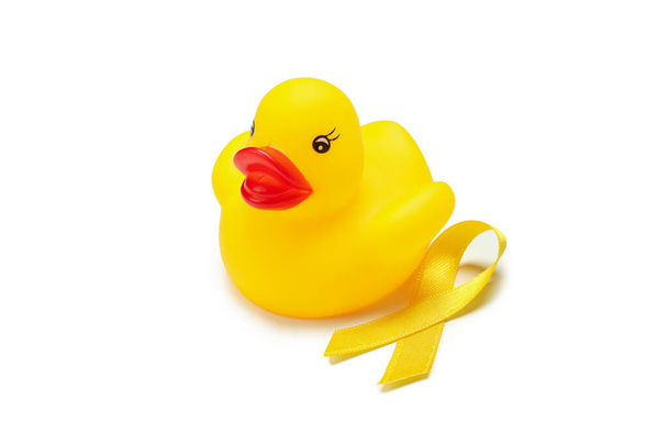 Yellow awareness ribbon and rubber duck isolated on white background - Photo, Image