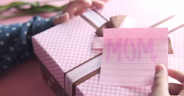 mother day concept of child hand holding pink color gift box  - Footage, Video