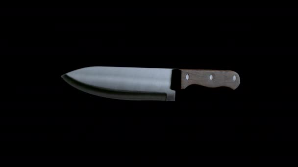Couteau de cuisine tournant vers le bas sur fond noir  - Séquence, vidéo