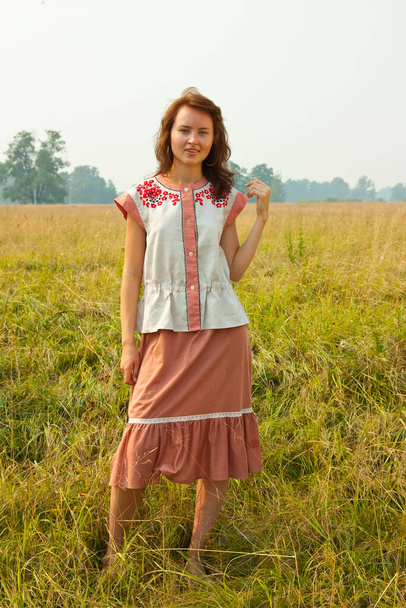 girl in traditional clothes  aganst summer nature - Photo, Image