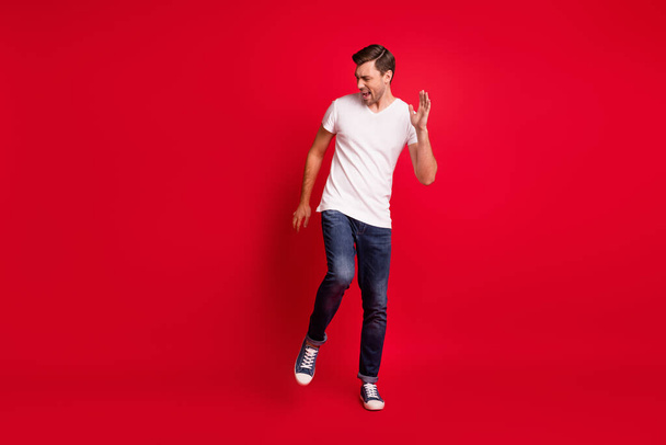 Full size photo of young satisfied man danceng open mouth shout yes isolated on dark red color background - Photo, Image