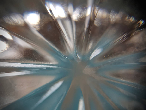 Starr burst of light with a blue tinge. This is light from the bottom of a glass - Photo, Image