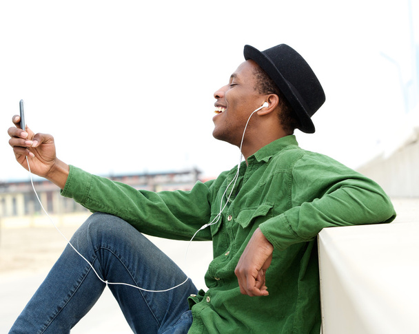 Young man listening to music on cellphone - Photo, Image