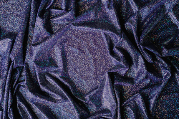 Purple holographic fabric. Beautiful folds in the fabric. Background for your subject - Foto, Bild
