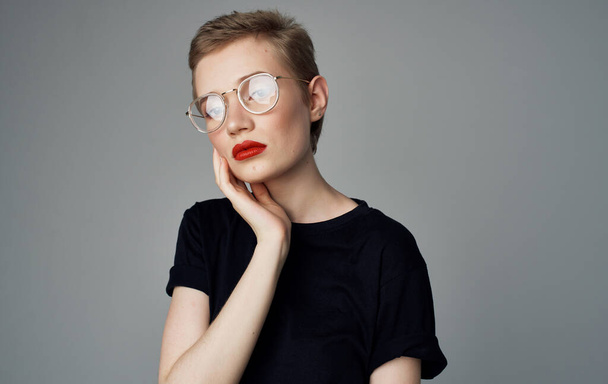 Pretty woman from short haircut and red lips black t-shirt smile model - 写真・画像