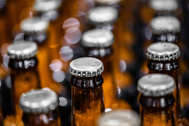 Close up dark beer in glass bottle on Brewery production line industry - Photo, Image