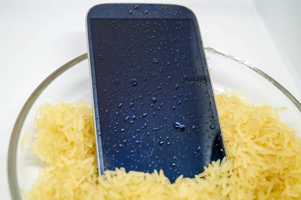 Wet mobile phone in rice - Photo, Image