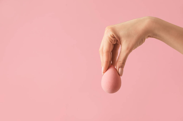 Hand with makeup sponge on color background - Photo, Image