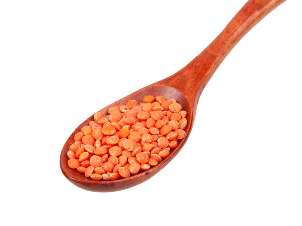Red lentil in wooden spoon isolated on the white background - Photo, Image