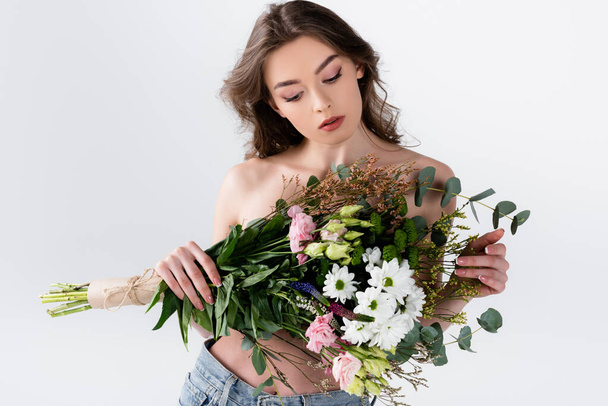 Shirtless model holding floral bouquet isolated on grey  - Φωτογραφία, εικόνα