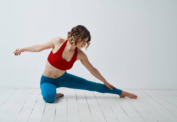 Sports woman yoga asana meditation in a light room gestures with her hands - Foto, Imagen