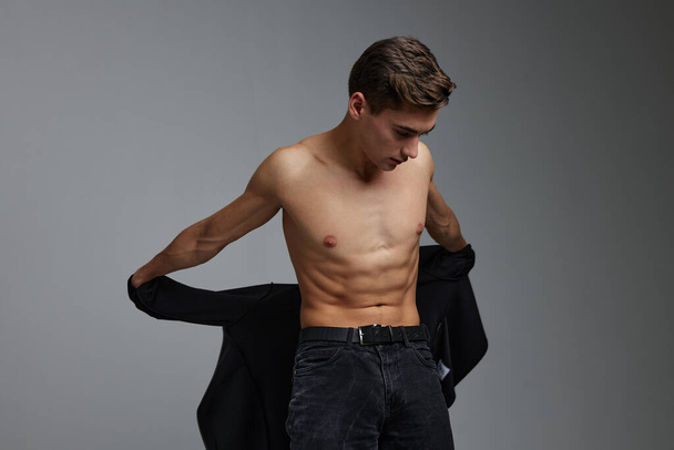 Nice man nude torso black shirt in the hands of moda Studio attractiveness - Photo, Image