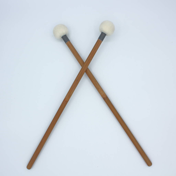 Crossed timpani mallets on a white background. - Photo, Image