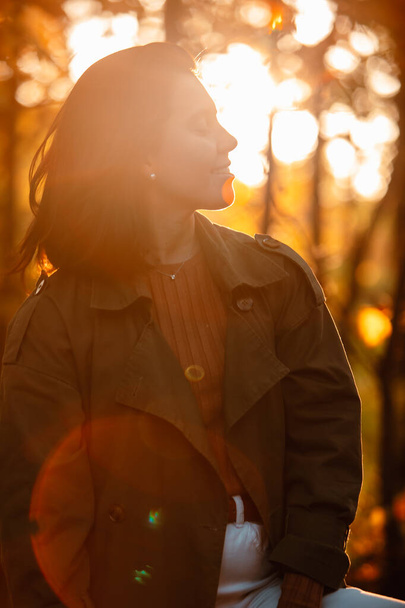 portrait of woman at sunset time sun back light autumn outfit - Photo, Image