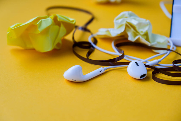 Ses kaset bantlı Hedphone 'lar ve sarı arka planda buruşmuş kağıt, boşluğu kopyala. Podcast bölümü. Audiobooks. - Fotoğraf, Görsel