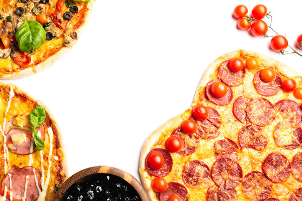 different various kind of pizzas in assortment with cherry tomato and black olives in wooden bowl, copy space, top view - Foto, imagen