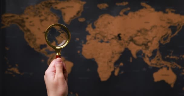 magnifying glass guides the world map - Footage, Video