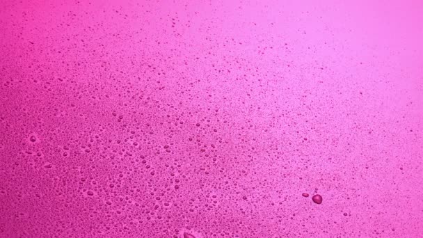 abstrakcyjny różowy kolor tło z kroplami wody - Materiał filmowy, wideo