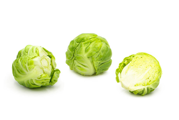 Fresh organic brussels sprouts whole and half isolated on white background. - Photo, Image