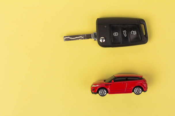 Red car and key. Concept of the automobile loan, saving money for car, trade car for cash, the concept of Finance. - Photo, Image