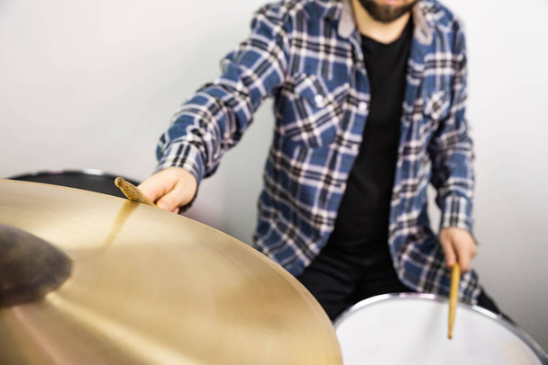 Professional drum set closeup. Man drummer with drumsticks playing drums and cymbals, on the live music rock concert or in recording studio    - Foto, immagini