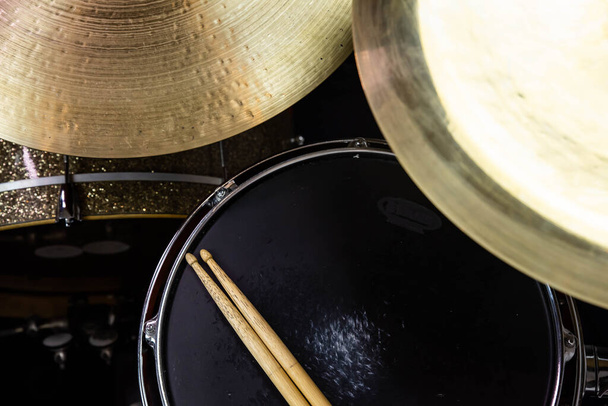 Closeup of drumsticks lying on the professional drum set. Drummer equipment.  - Photo, Image