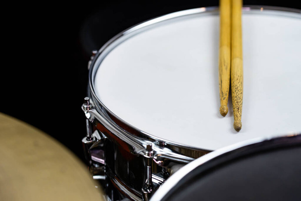 Closeup of drumsticks lying on the professional drum set. Drummer equipment.  - Фото, изображение