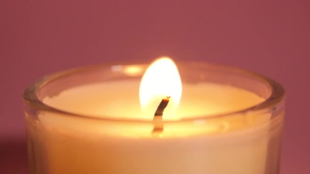https://cdn.create.vista.com/api/media/small/451342130/stock-video-burning-candle-close-pink-background-slow-motion-video-candle-flame?videoStaticPreview=true&token=
