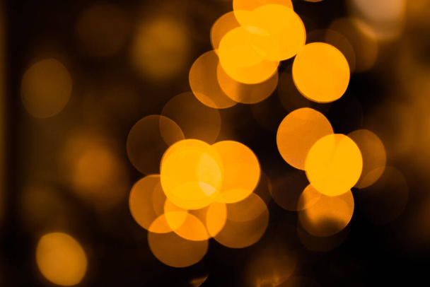 Gold background. Soft focus. Selective focus. Defocus light.Abstract holiday background, beautiful shiny Christmas lights, glowing magic bokeh. - Photo, Image