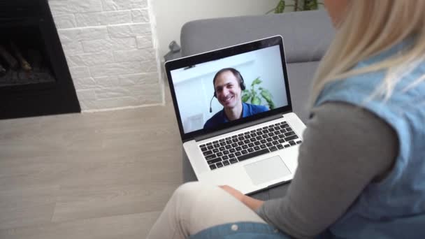 Video call. Remote work. A girl work from home. She communicate via video communication with colleagues using computer - Footage, Video