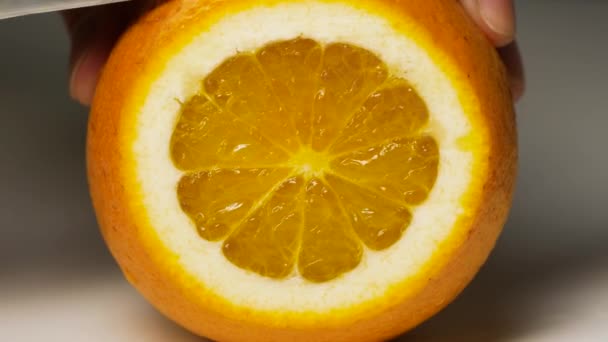Couper à la main des fruits orange frais. Alimentation saine, cuisine et régime alimentaire. - Séquence, vidéo