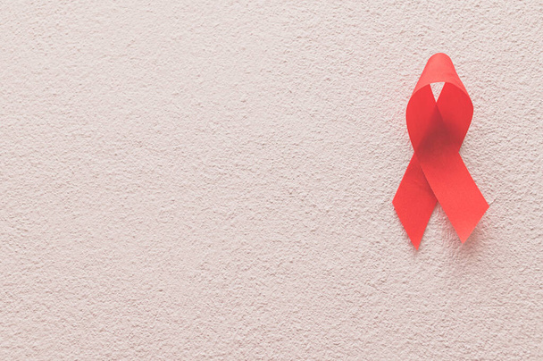 Red ribbon symbolizes world health day - 写真・画像