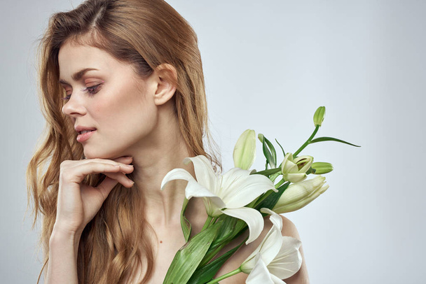 Συναισθηματική γυναίκα με λουλούδια μοντέλο άνοιξη γυμνοί ώμοι διαυγές δέρμα - Φωτογραφία, εικόνα