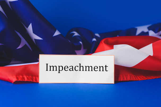 Paper with word IMPEACHMENT and USA flag on color background - Foto, Imagem