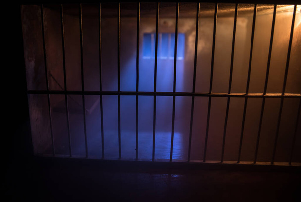 Parmaklıklar ardında. Eskimiş grunge beton oda minyatürü. Karanlık hapishane iç dekorasyonu. Boş hücre. Seçici odak - Fotoğraf, Görsel
